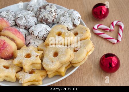 High angle view of plate with biscuit cookies on wooden table with Christmas ornaments Stock Photo