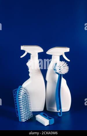 white bottles with reading fluid for glasses and brushes on a blue background, place for text. Stock Photo