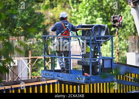 Man working on freight elevators on a construction site. Stock Photo