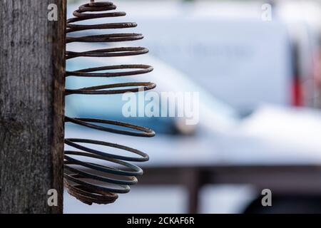 A closeup picture of an empty bird feeder. Shallow depth of field. Blurry background. Stock Photo