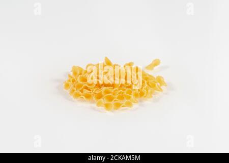 Close-up photo of pasta Farfalline on white background. Close-up raw uncooked delicious pasta Stock Photo