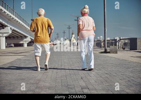 Active senior people working out on the quay Stock Photo