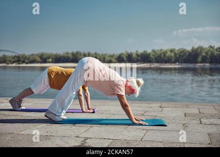 Married couple practicing yoga in the morning Stock Photo