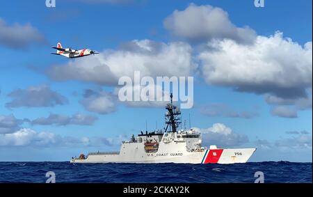 The crews of the Coast Guard Cutter Kimball (WMSL 756) and an Air Station Barbers Point HC-130 Hercules airplane conduct joint operations in the Pacific August 14, 2020. The crews were participating in the multi-country maritime Operation Nasse designed to prevent Illegal, unregulated or unreported (IUU) fishing in Oceania. (U.S. Coast Guard photo courtesy of the Coast Guard Cutter Kimball/Released) Stock Photo