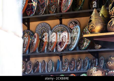 Souvenir shops on the Sevastopol embankment on August 13, 2020. Bright painted plates and vases. Colorful handmade tableware. Sale of art Souvenirs on Stock Photo