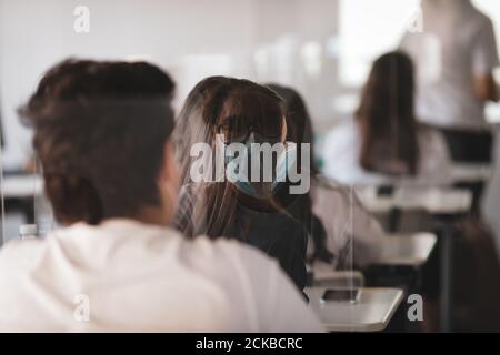 Bucharest, Romania - September 14, 2020: Shallow depth of field (selective focus) image with the reflection of a high school pupil in a separator, dur Stock Photo