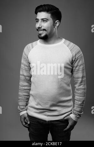 Young bearded Iranian man against gray background Stock Photo