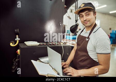 Male worker using modern laptop at work Stock Photo