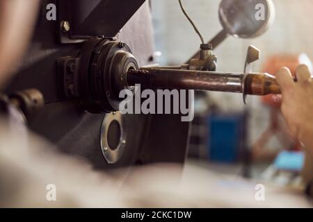 Male worker using industrial coffee roasting machine Stock Photo