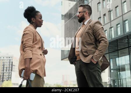 Two business partners talking to each other during meeting in the city Stock Photo