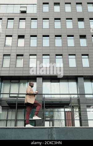 African businessman standing against the modern office building in the city Stock Photo