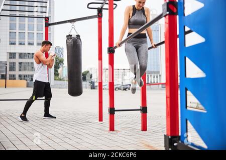 Young athletic couple doing sport on sports ground Stock Photo