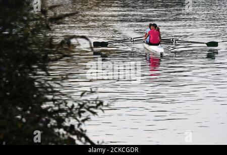 Rowers travel along the River Thames near Maidenhead, Berkshire. Stock Photo