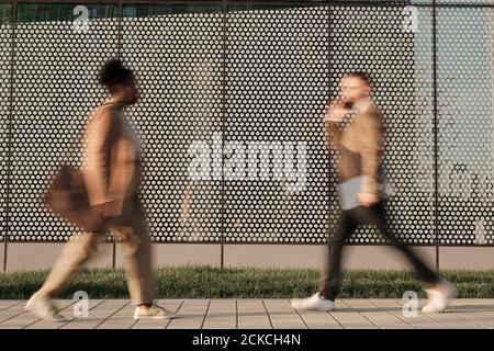 Blurred motion of people walking along the street in the city Stock Photo