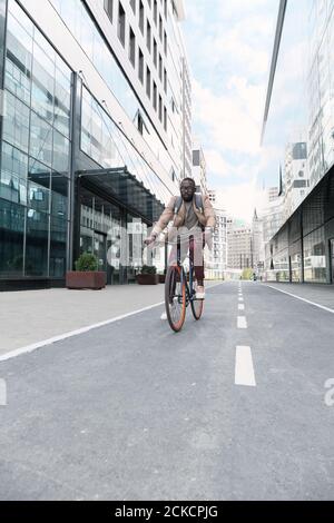 African young man riding on a bike along the streets in the city Stock Photo