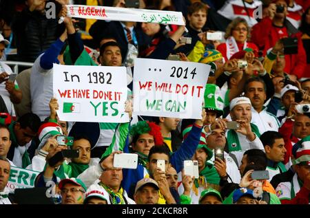 Fans of Algeria hold up signs as they wait for the start of their 2014 World Cup round of 16 game against Germany at the Beira Rio stadium in Porto Alegre June 30, 2014. REUTERS/Stefano Rellandini (BRAZIL  - Tags: SOCCER SPORT WORLD CUP)