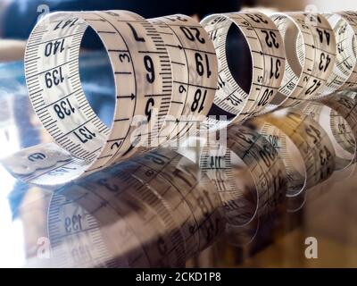 Tape measure, used by dressmakers and tailors to take measurements of the clothes to be made. Stock Photo