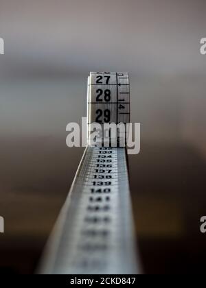 Tape measure, used by dressmakers and tailors to take measurements of the clothes to be made. Stock Photo