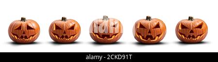 A group of five unlit spooky halloween pumpkins, Jack O Lantern with evil face and eyes isolated against a white background. Stock Photo