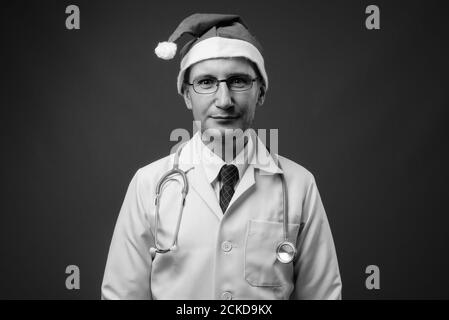 Portrait of man doctor with Santa hat ready for Christmas Stock Photo