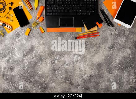 Border from office supplies and gadgets on the desk. Top view with copy space Stock Photo