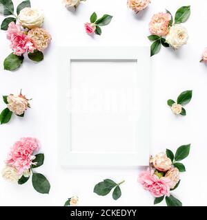 roses and cloves, branches, floral pattern on white background. Flat lay, top view. Valentine's background. Floral frame. Frame of flowers. Stock Photo