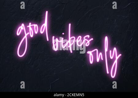 Good vibes only written in pink neon style on black wall background Stock Photo