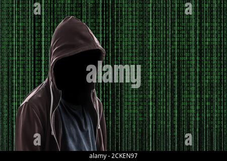 Invisibla man wearing a hoodie on Matrix style background Stock Photo
