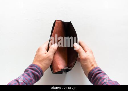 the man shows an empty purse with no money. concept of poverty Stock Photo