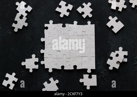 puzzle design and missing puzzle pieces on black background Stock Photo