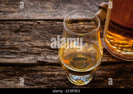 glencairn whiskey glass with single malt whiskey with space for text on a wooden background Stock Photo