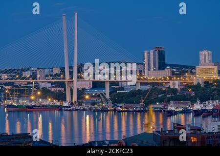 Vladivostok, Russia - Jun 11, 2020: Night view of the city of Vladivostok. Golden bridge in Vladivostok at night. Stock Photo
