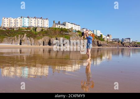 Tenby, Pembrokeshire, Wales, UK. 16th Sep, 2020. A woman enjoys the south beach in Tenby, Pembrokeshire, with her little 18-month-old son, as another warm day is promised. Credit: Peter Lopeman/Alamy Live News Stock Photo