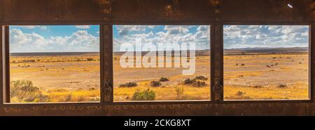 Negev Desert landscape as seen through a window in an abandoned building, Negev, Israel Stock Photo