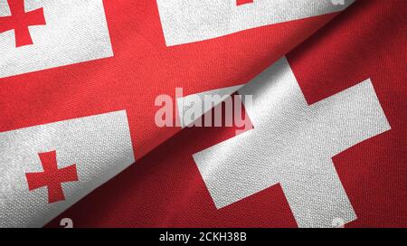 Georgia and Switzerland two flags textile cloth, fabric texture Stock Photo