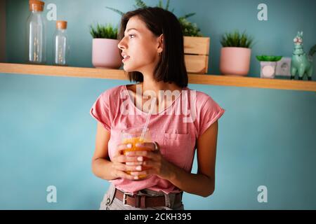 Portrait of pretty woman holding glass with tasty juice Stock Photo
