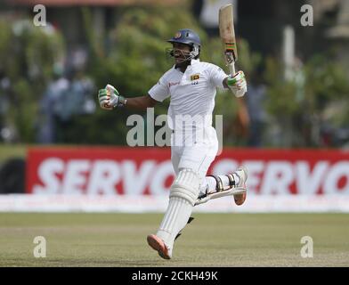 Sri Lanka's Dinesh Chandimal celebrates his century during the third day of their first test cricket match against India in Galle August 14, 2015. REUTERS/Dinuka Liyanawatte