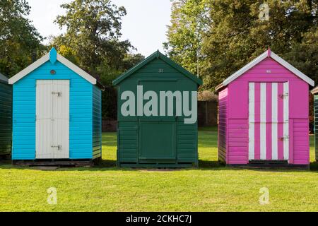 Three colourful wooden beach huts at the british seaside Stock Photo