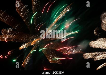 Light spots of green fireworks at a long exposure on a black background. Festive background. Stock Photo