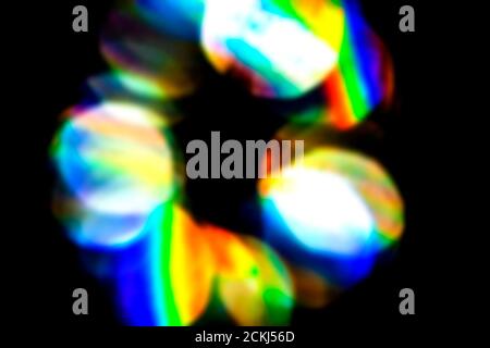 Lens flare, Bokeh lights. Reflections from glass, diamond, crystal. Defocused shining colorful rainbow light leaks, rays on black background Stock Photo