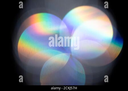 Lens flare, Bokeh lights. Reflections from glass, diamond, crystal. Defocused shining colorful rainbow light leaks, rays on black background Stock Photo