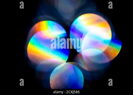 Lens flare, Bokeh lights. Reflections from glass, diamond, crystal. Defocused shining colorful rainbow light leaks, rays on black background Stock Photo