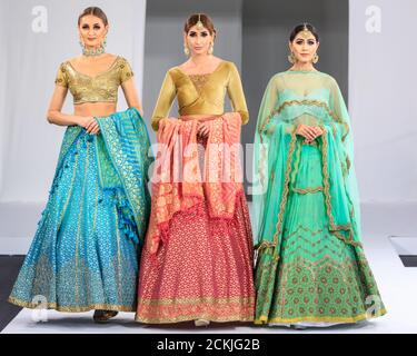 Models in Asian wedding dress bridal or occasional wear, National Asian Wedding Show fashion runway, London Stock Photo