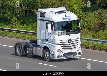 White Wincanton Haulage delivery trucks, lorry, transportation, truck, cargo carrier, Mercedes Benz Actros vehicle, European commercial transport industry HGV, M6 at Manchester, UK Stock Photo