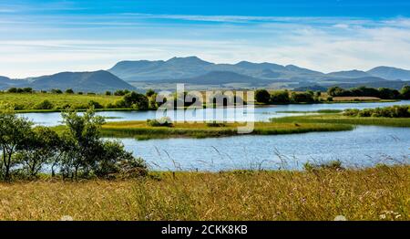 Lake of Bordes on the Cezallier plateau in the Auvergne volcanoes regional natural park. Behind Massif of Sancy. Puy de Dome, Auvergne. France Stock Photo