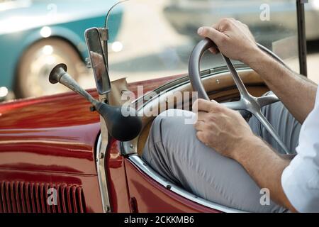 Italy, Lombardy, Meeting of Vintage Car, Man Driving a Vintage Car Stock Photo