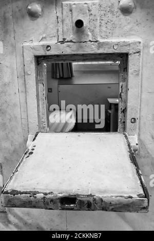 Open hatch of prison cell with a look inside the cell Netherlands Stock Photo