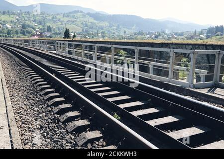 Train rails in country landscape. Railroad tracks at sunset time. Local travel concept Stock Photo
