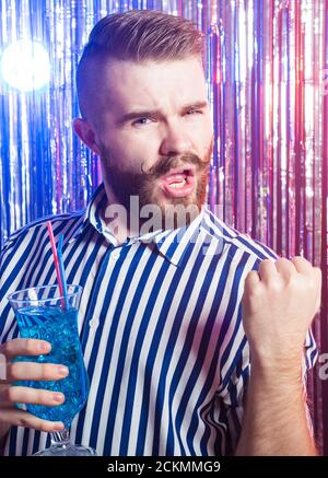 Alcoholism, fun and fool concept - Drunk crazy guy at party in a