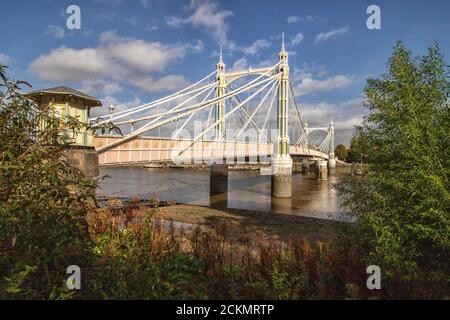 View towards Albert Bridge from the Thames river walk, Battersea, Greater London, United Kingdom, Europe Stock Photo
